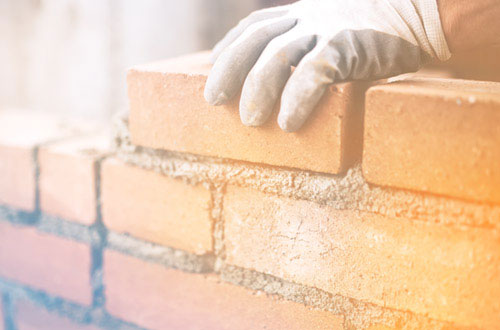Builder laying bricks